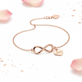 Rose gold infinity bracelet with love charm on delicate chain